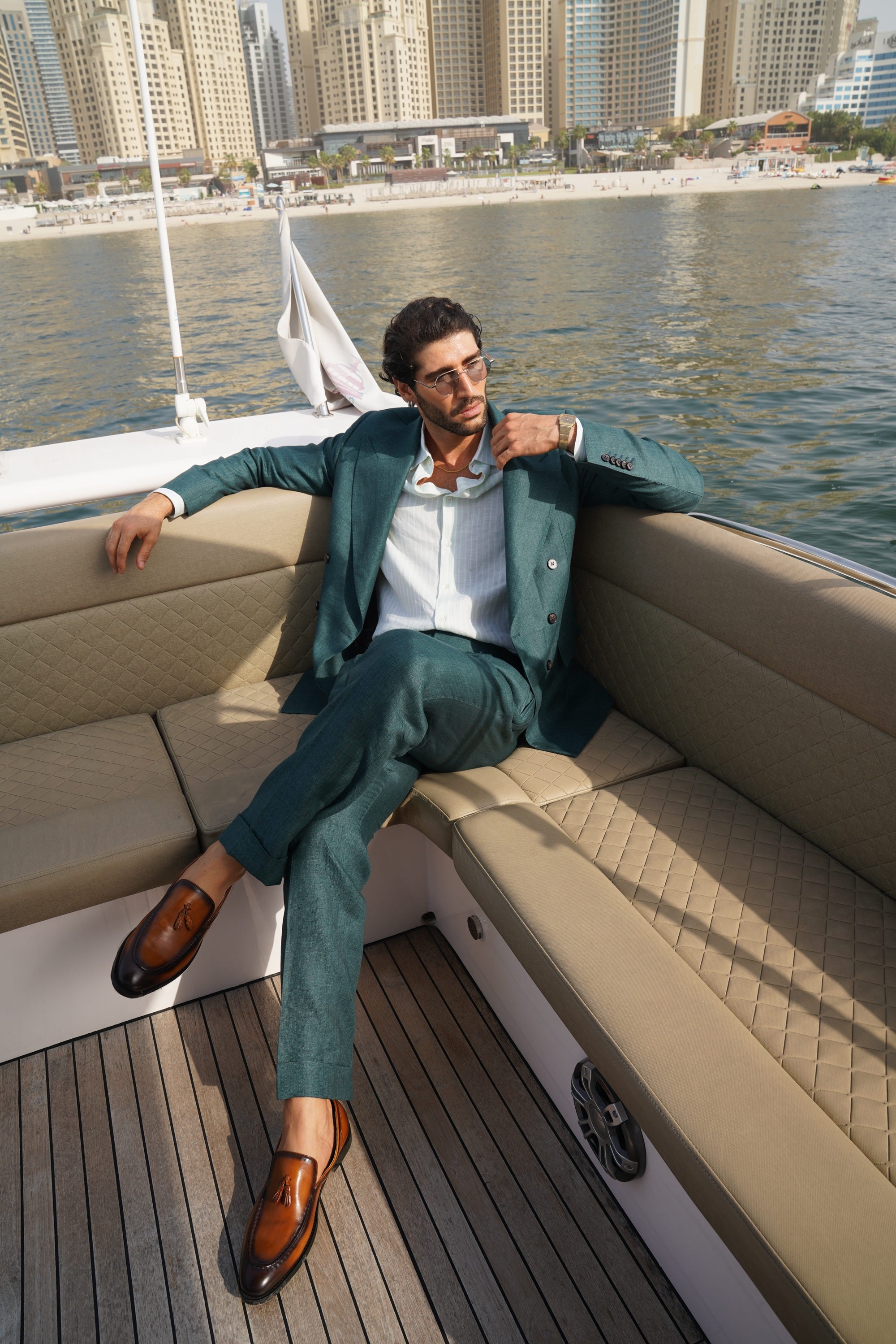 Bottle green double-breasted suit in a silk and linen blend with a peak lapel