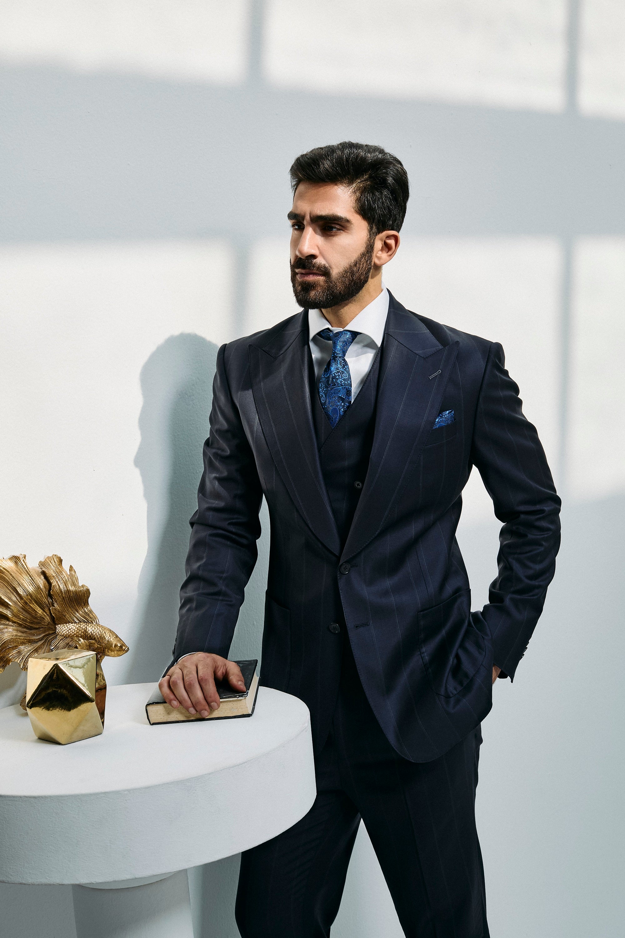 Navy wool three-piece suit, single-breasted with a peak lapel