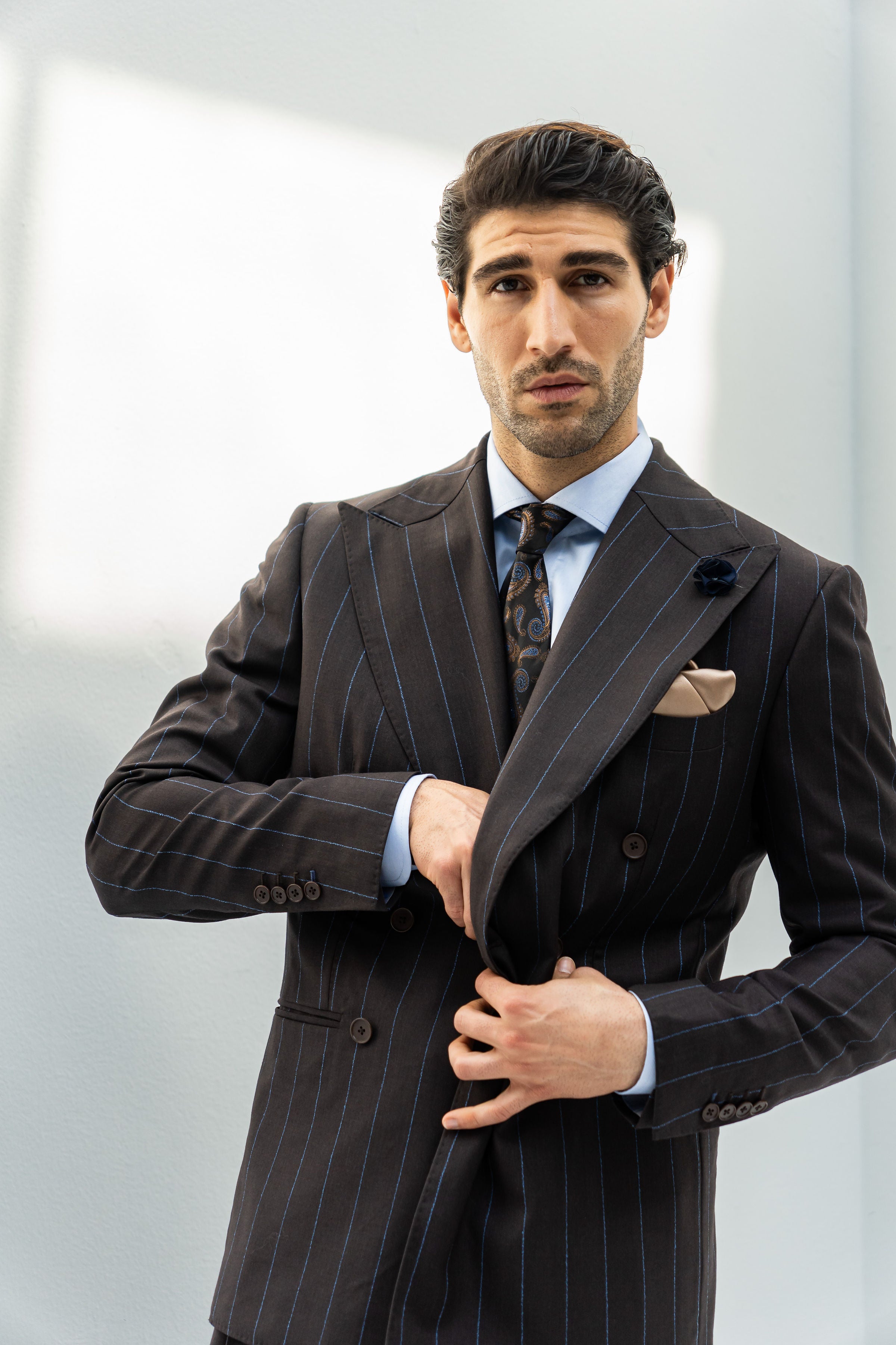 Coffee pinstripe wool suit with a double-breasted front and notch lapel